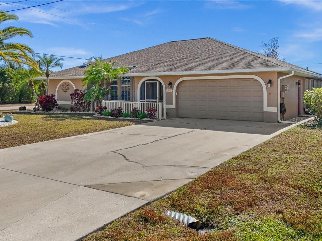 25263 Padre Lane Punta Gorda, FL 33983 - Photo 6 of 60 a front view of a house with a yard and garage