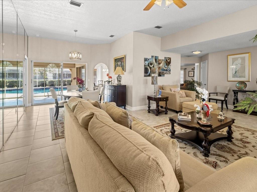 25263 Padre Lane Punta Gorda, FL 33983 - Photo 10 of 60 a living room with furniture and a chandelier