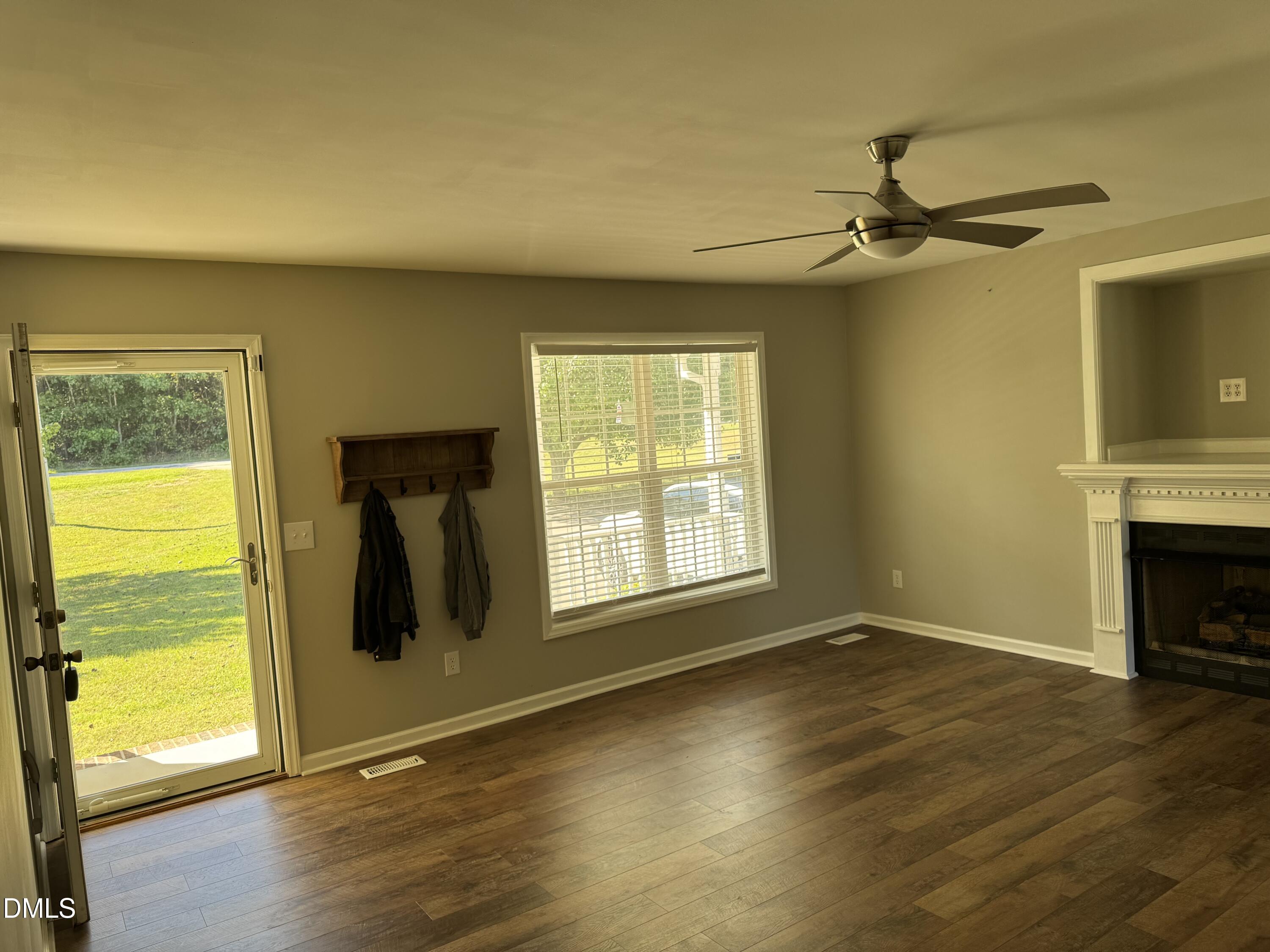 1318 Bobbitt Road Kittrell, NC 27544 - Photo 5 of 15 a view of an empty room with a window and wooden floor