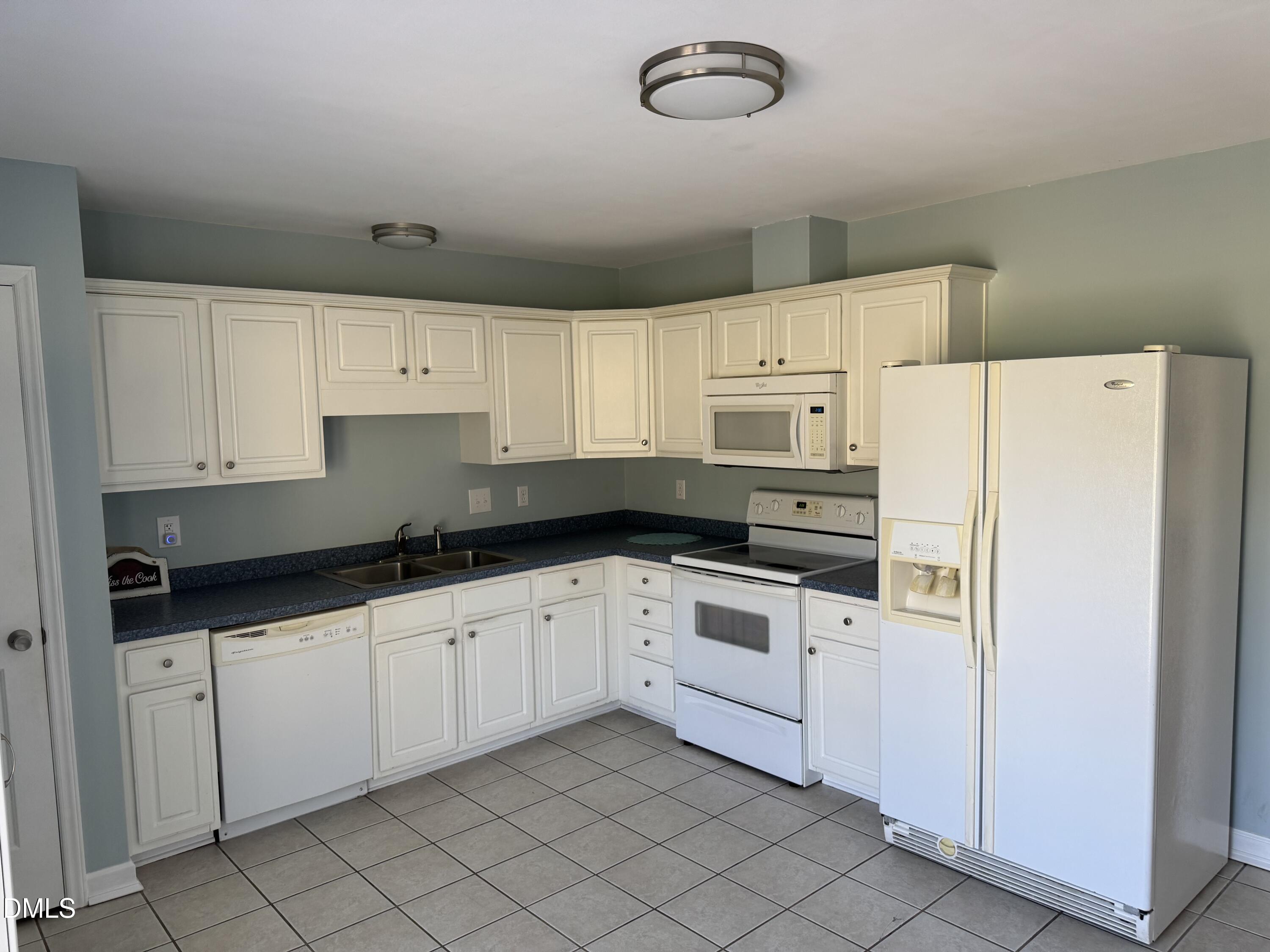 1318 Bobbitt Road Kittrell, NC 27544 - Photo 6 of 15 a kitchen with granite countertop white cabinets and white appliances