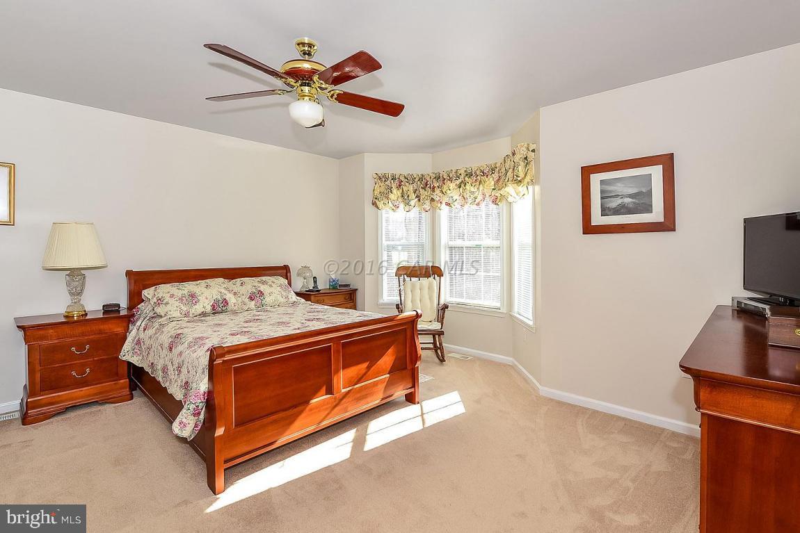 2 Falcon Bridge Road Ocean Pines, MD 21811 - Photo 22 of 46 a bed room with a bed and a tv