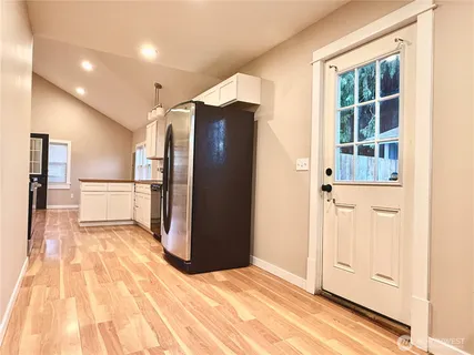 a view of a refrigerator in kitchen and wooden floor