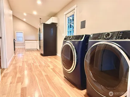 a view of a bathroom with washing machine and dryer