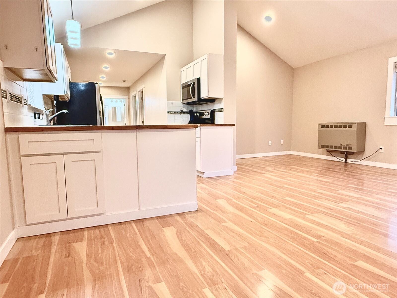 1010 Talcott Street Sedro-Woolley, WA 98284 - Photo 5 of 27 a view of a kitchen with stainless steel appliances wooden floor and a window