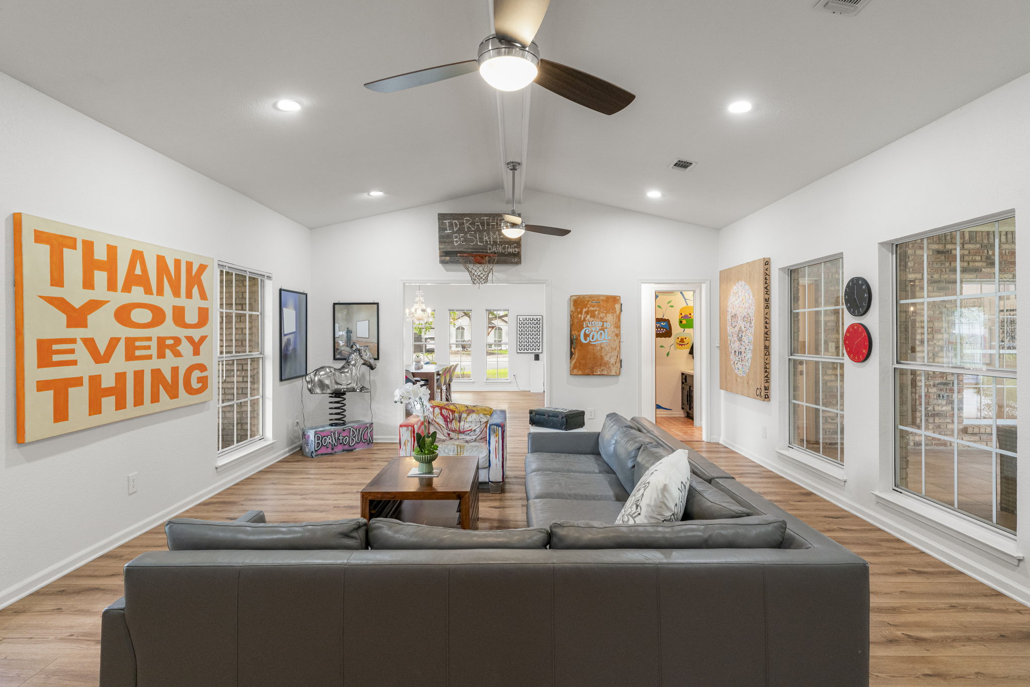 400 Hackberry Street Lockhart, TX 78644 - Photo 11 of 40 Vast living area showcasing wood-look flooring and soaring vaulted ceilings, perfect for entertaining.