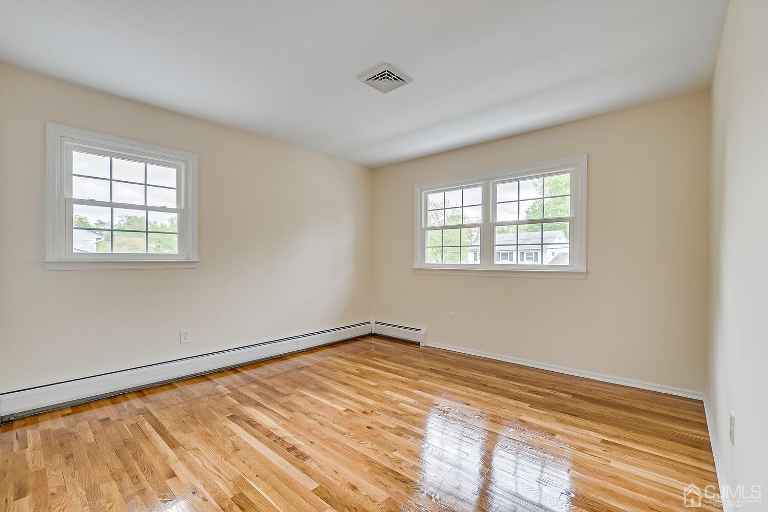8 Eagle Road Edison, NJ 08820 - Photo 14 of 28 a view of an empty room with wooden floor and a window