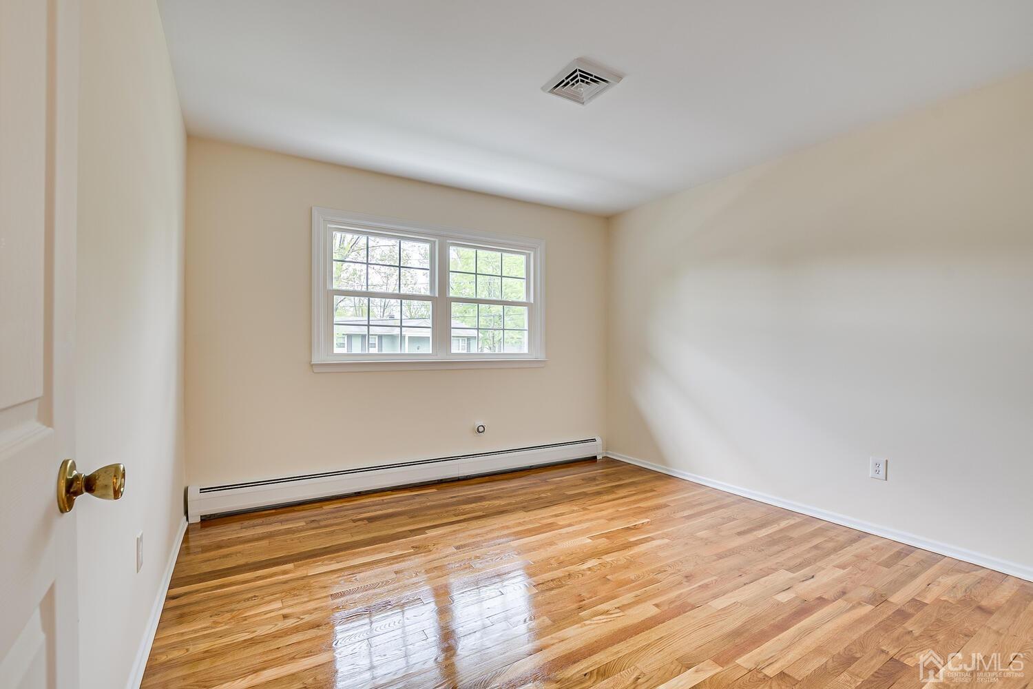 8 Eagle Road Edison, NJ 08820 - Photo 15 of 28 an empty room with wooden floor and windows