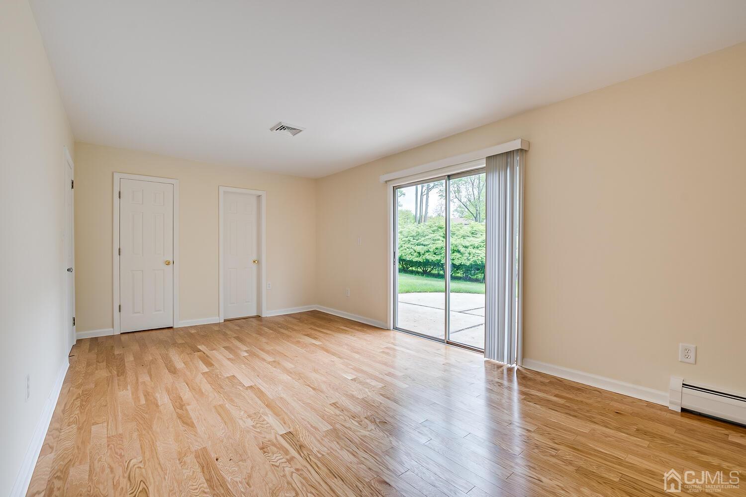 8 Eagle Road Edison, NJ 08820 - Photo 17 of 28 a view of an empty room with wooden floor and a window