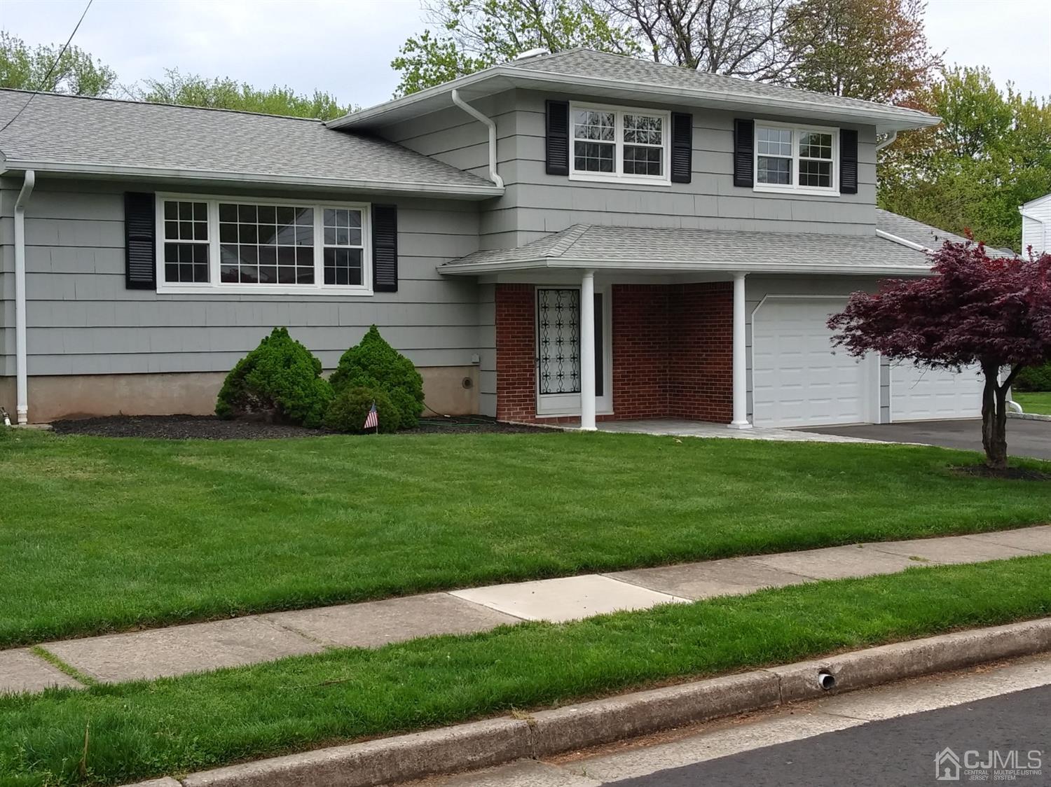 8 Eagle Road Edison, NJ 08820 - Photo 27 of 28 a front view of a house with a garden and yard