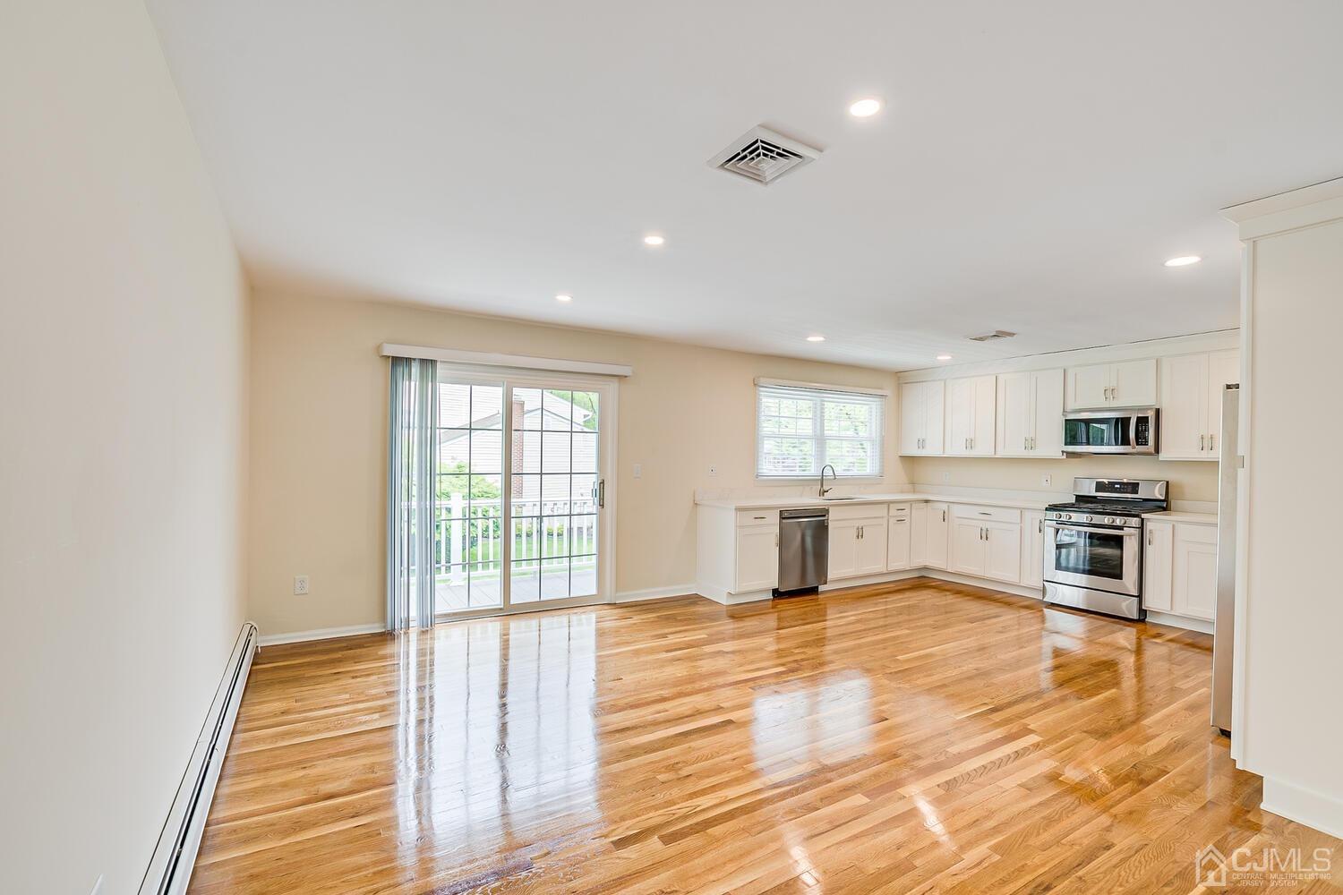 8 Eagle Road Edison, NJ 08820 - Photo 5 of 28 a view of a kitchen with kitchen island stainless steel appliances wooden floor and window