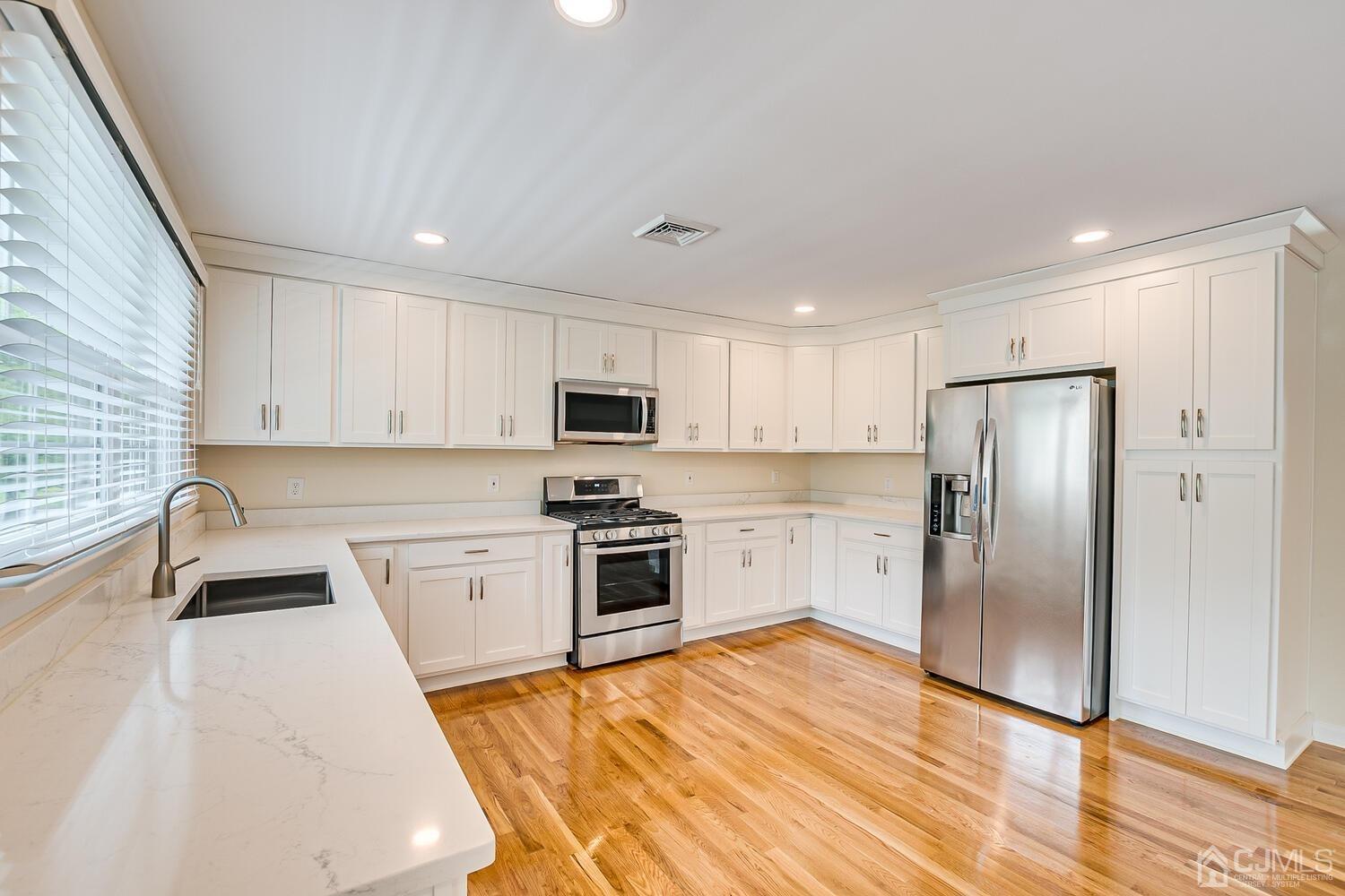 8 Eagle Road Edison, NJ 08820 - Photo 7 of 28 a kitchen with stainless steel appliances granite countertop a refrigerator sink and stove