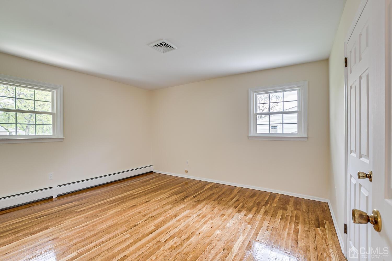 8 Eagle Road Edison, NJ 08820 - Photo 10 of 28 an empty room with wooden floor and windows