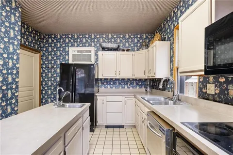 a kitchen with a sink stove and refrigerator