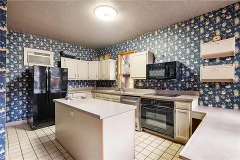 a kitchen with a sink stove and cabinets