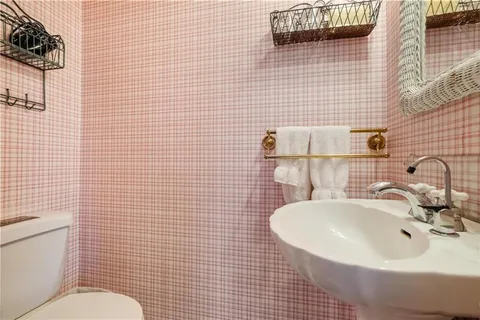 a living room with furniture a fireplace and large windows