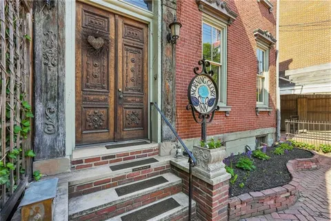 a front view of a house with a garden