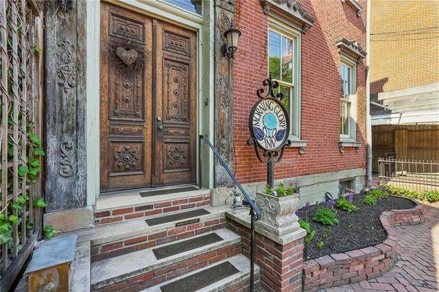 a front view of a house with a garden