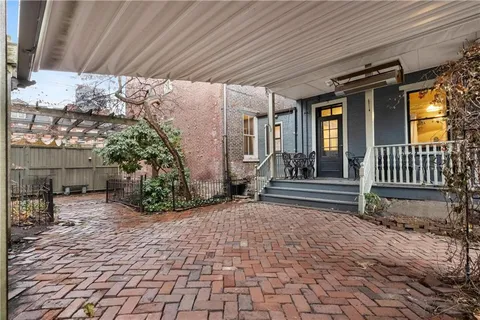 a view of a house with large trees and a wooden roof