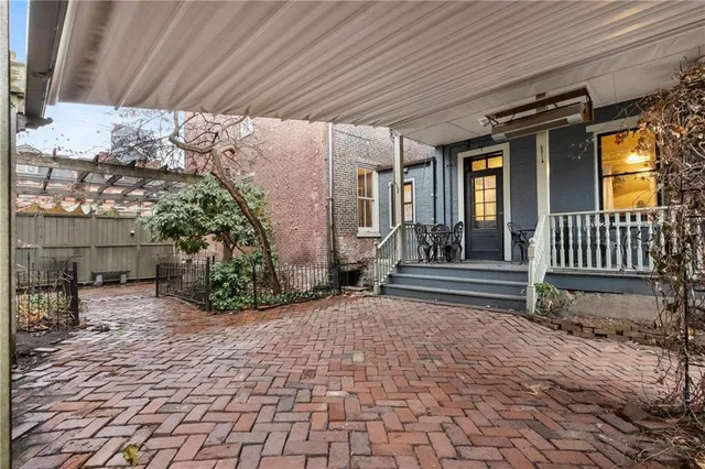 a view of a house with large trees and a wooden roof