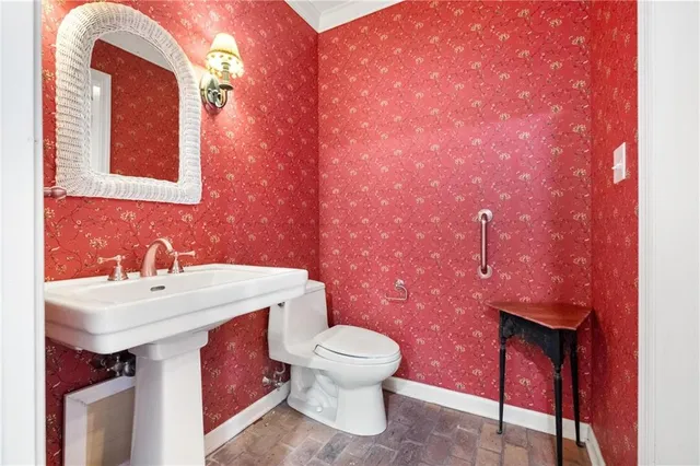 a kitchen with white cabinets stainless steel appliances and wooden floor