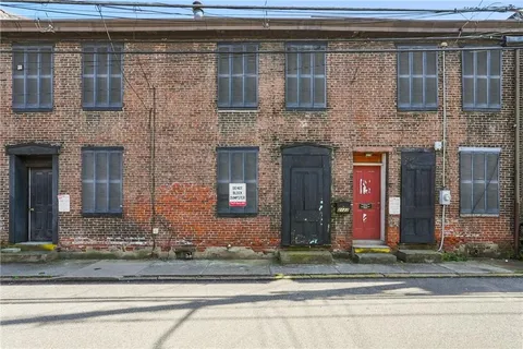 an aerial view of a house with a yard and lake view
