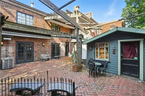 a balcony with table and chairs