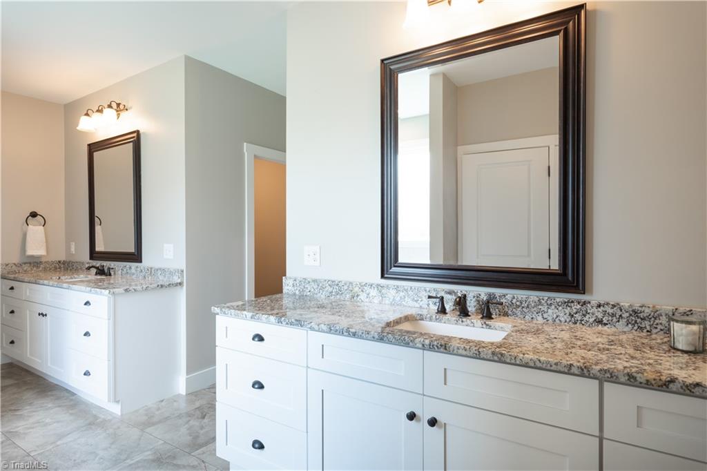 393 Scout Road Lexington, NC 27292 - Photo 29 of 47 Generous counterspace is an understatement! This ensuite not only offers separate vanities but tons of storage space as well!