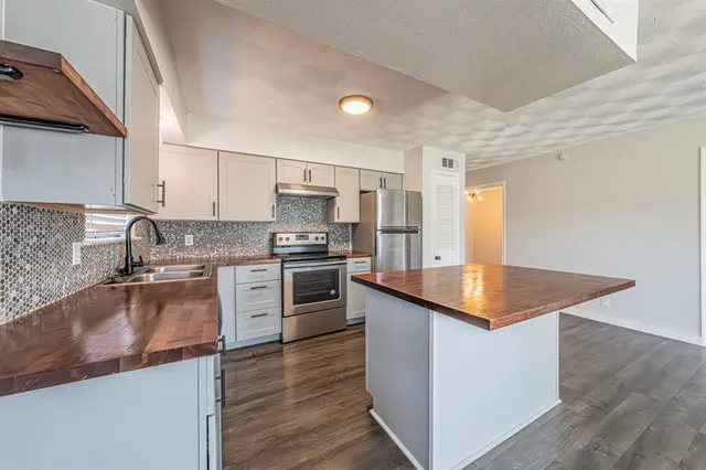 a view of kitchen with livingroom and wooden floor