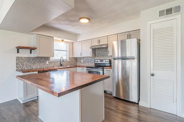 a kitchen with granite countertop a sink and appliances