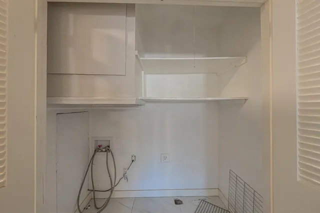 a kitchen with cabinets wooden floor and a window