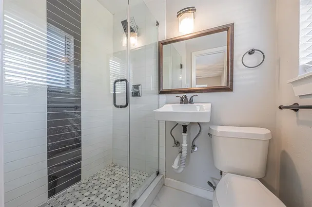 a view of a room with a ceiling fan and a kitchen