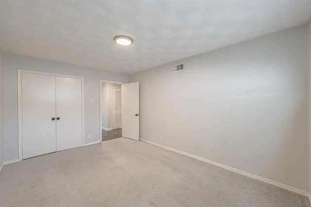 an empty room with a empty space and windows