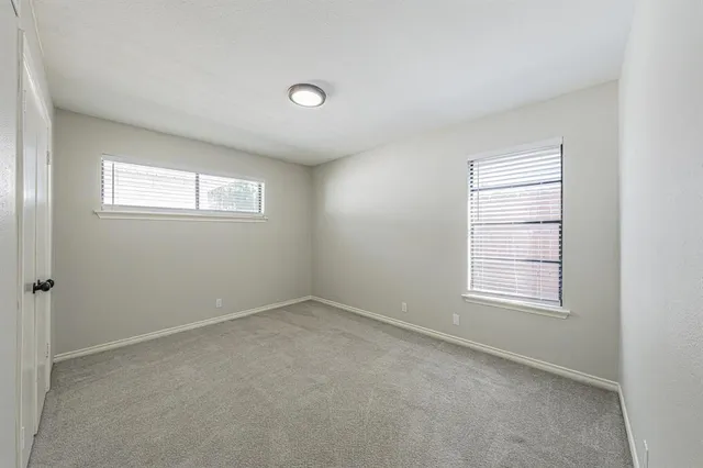 a kitchen with wooden floors and refrigerator