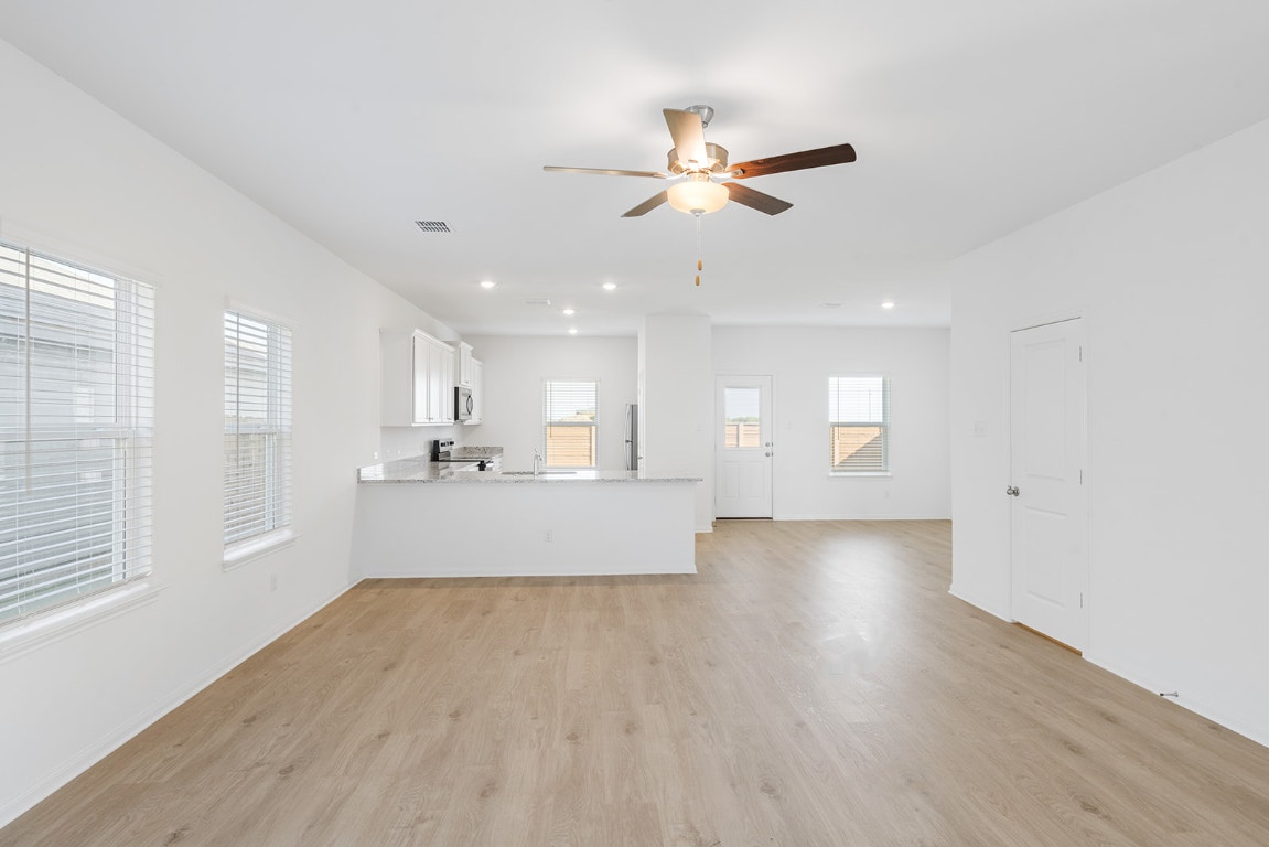 108 Paria Court Jarrell, TX 76537 - Photo 2 of 6 a view of a kitchen with wooden floor and a window