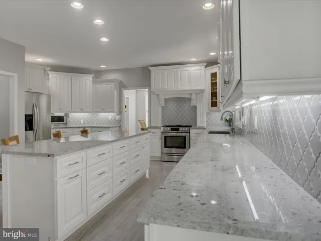 a view of staircase with wooden floor and a front door