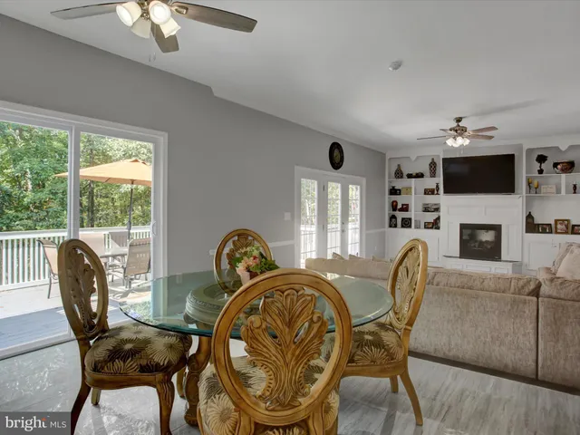 a view of an empty room with a fireplace and a window