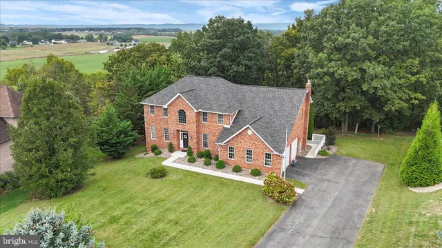 an aerial view of a house with swimming pool garden and patio