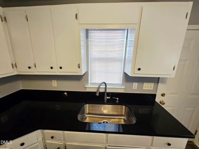 a kitchen with a sink and cabinets