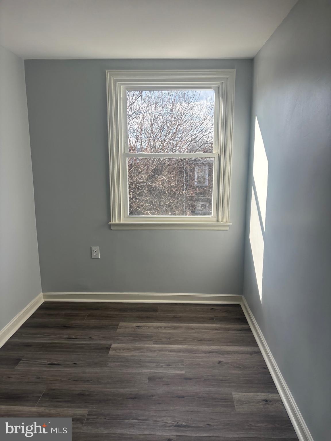 1870 Pratt Street Philadelphia, PA 19124 - Photo 6 of 23 a view of an empty room with wooden floor and a window