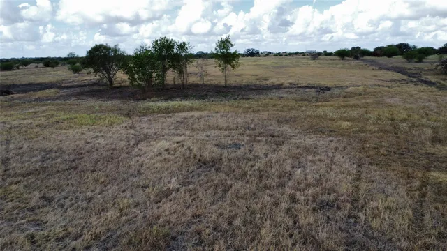 a view of a lake with beach and green space