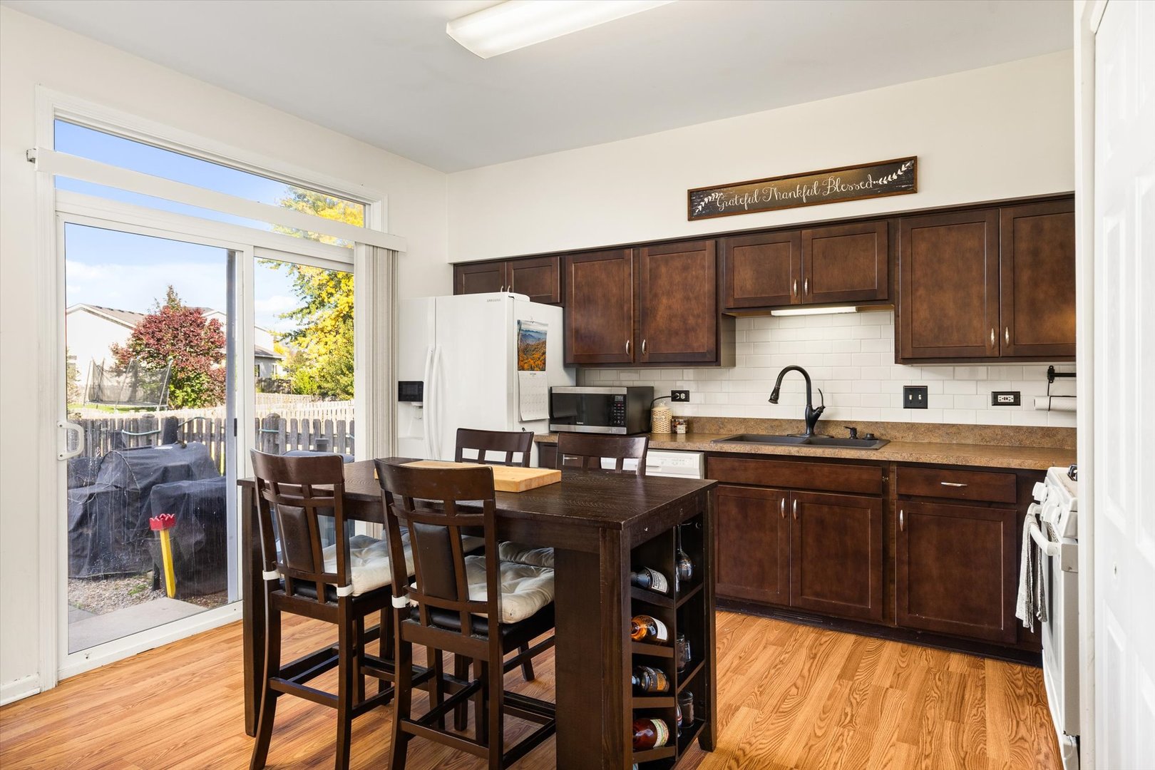 2267 Margaret Drive Montgomery, IL 60538 - Photo 11 of 35 a kitchen with a table chairs sink and cabinets