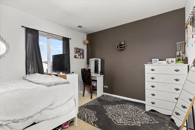 a bedroom with a bed and a tv