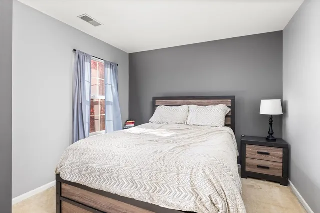 a bedroom with a large bed and a flat screen tv