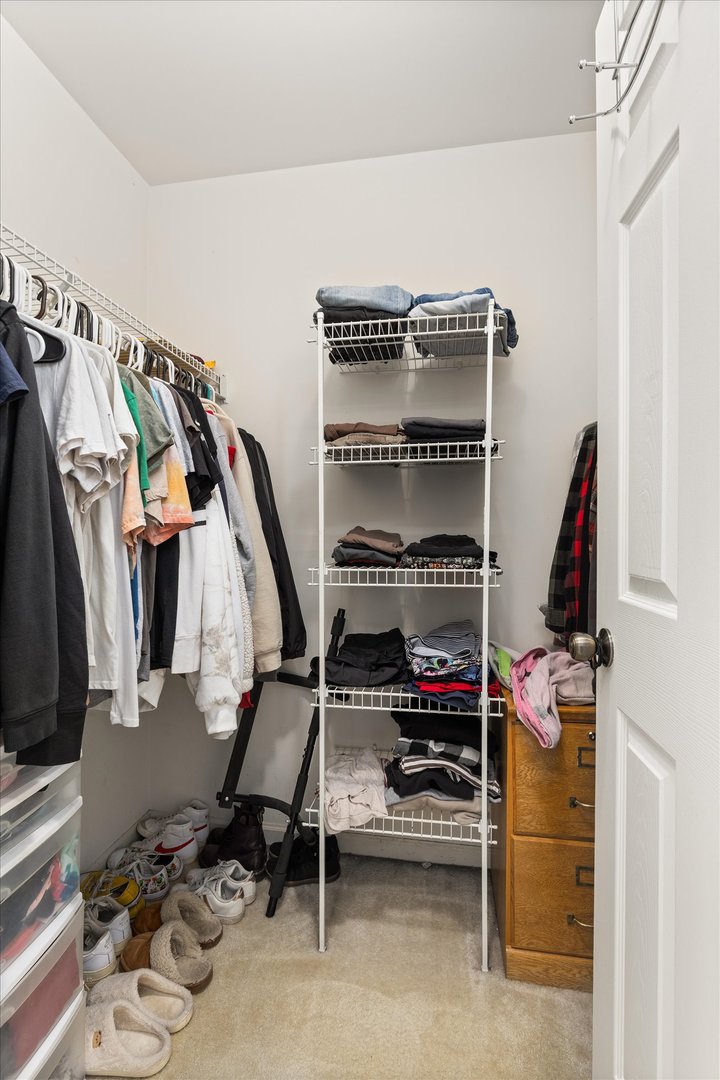 2267 Margaret Drive Montgomery, IL 60538 - Photo 24 of 35 a view of walk in closet with clothes and shoes