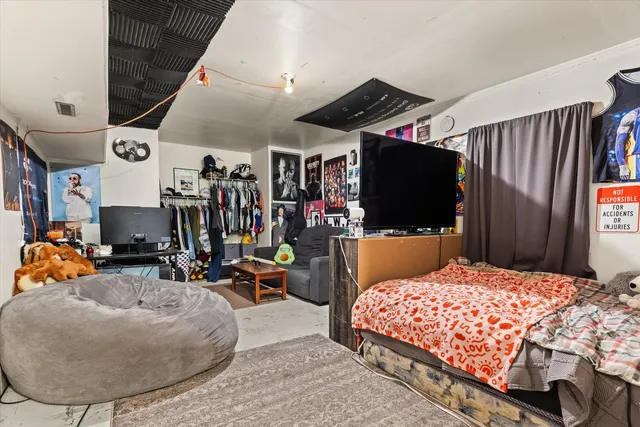 a view of a work space with furniture and flat screen tv