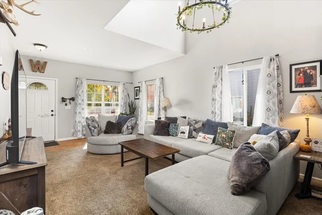 a living room with furniture and stairs