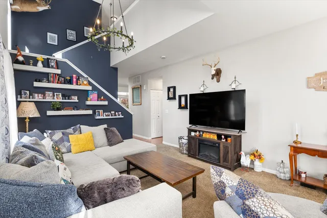 a living room with furniture and a chandelier