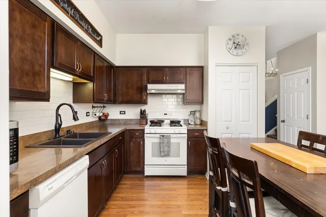 a kitchen with a table chairs sink and cabinets