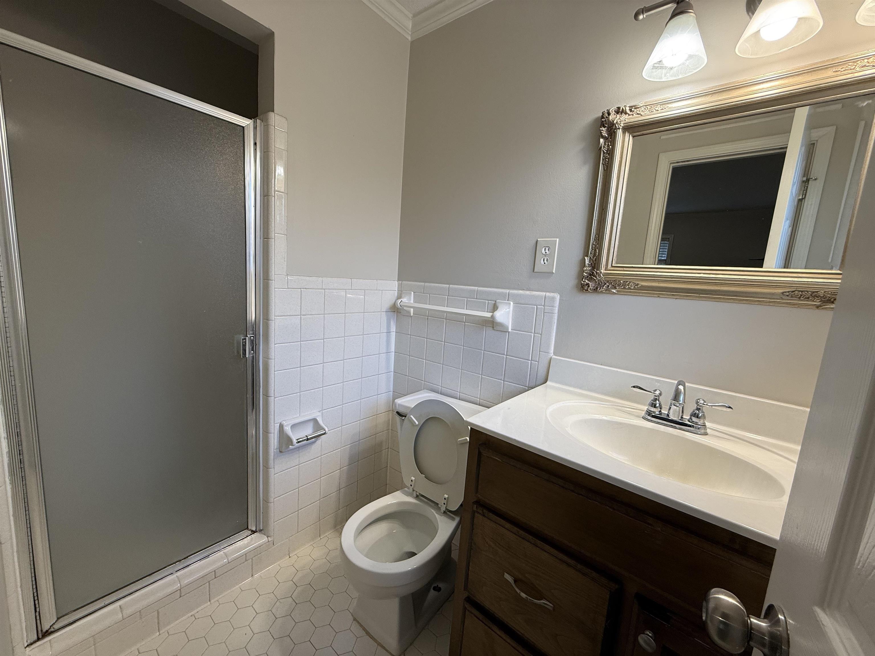 5701 Baird Drive Memphis, TN 38119 - Photo 9 of 12 Bathroom featuring tile patterned flooring, vanity, ornamental molding, a stall shower, and tile walls
