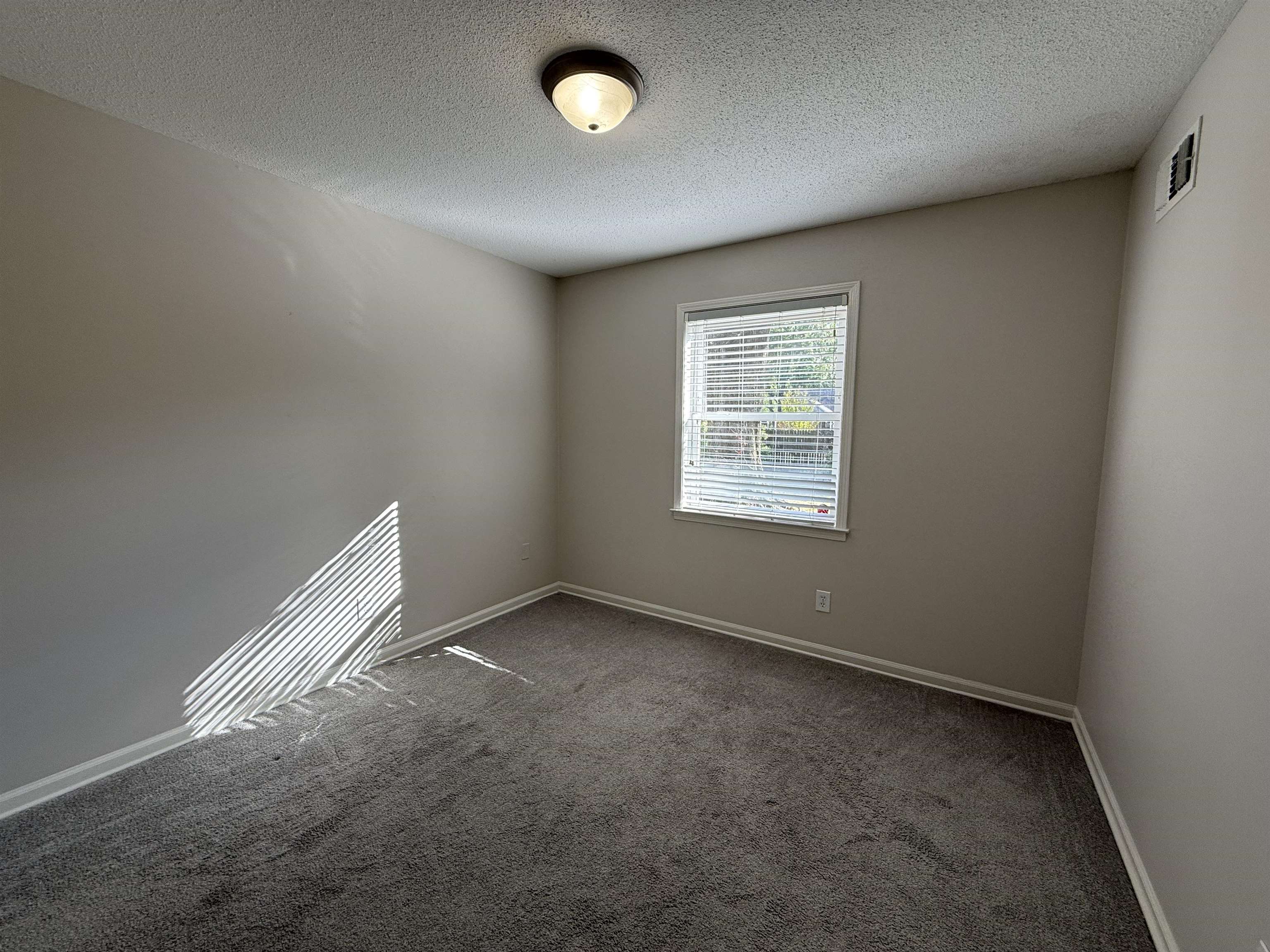 5701 Baird Drive Memphis, TN 38119 - Photo 10 of 12 Carpeted empty room with a textured ceiling and baseboards